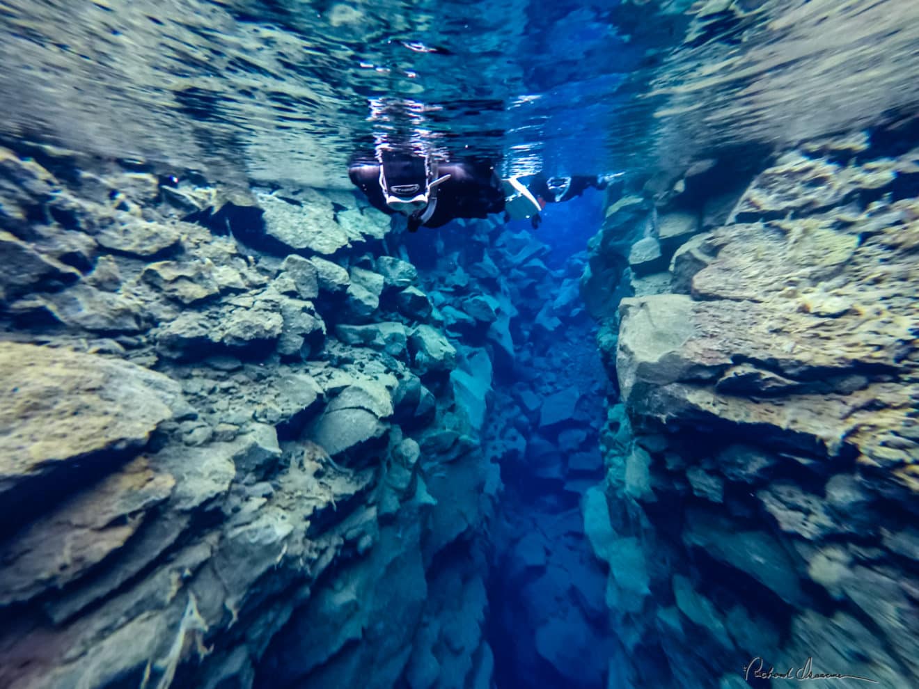 Unique diving between the two tectonic plates at Silfra in Iceland Mr