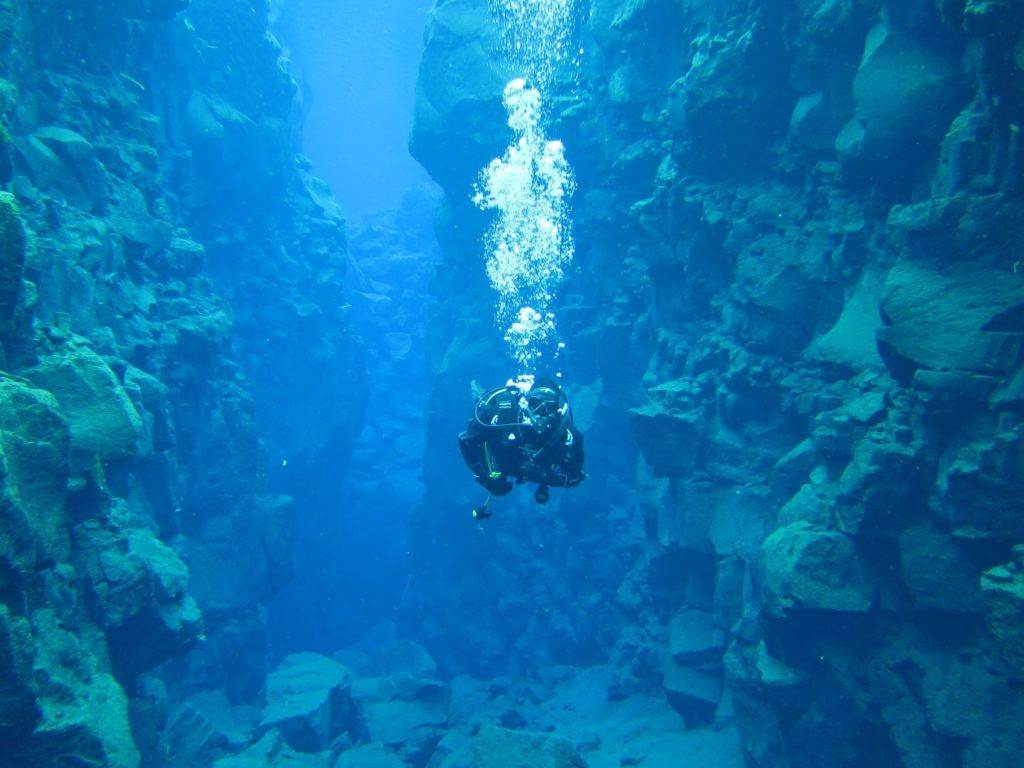 Unique diving between the two tectonic plates at Silfra in Iceland Mr