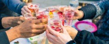 people holding clear drinking glasses