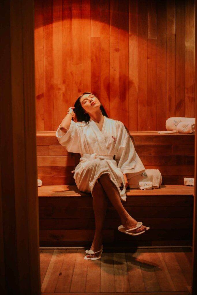 A Woman Wearing a Robe in a Sauna