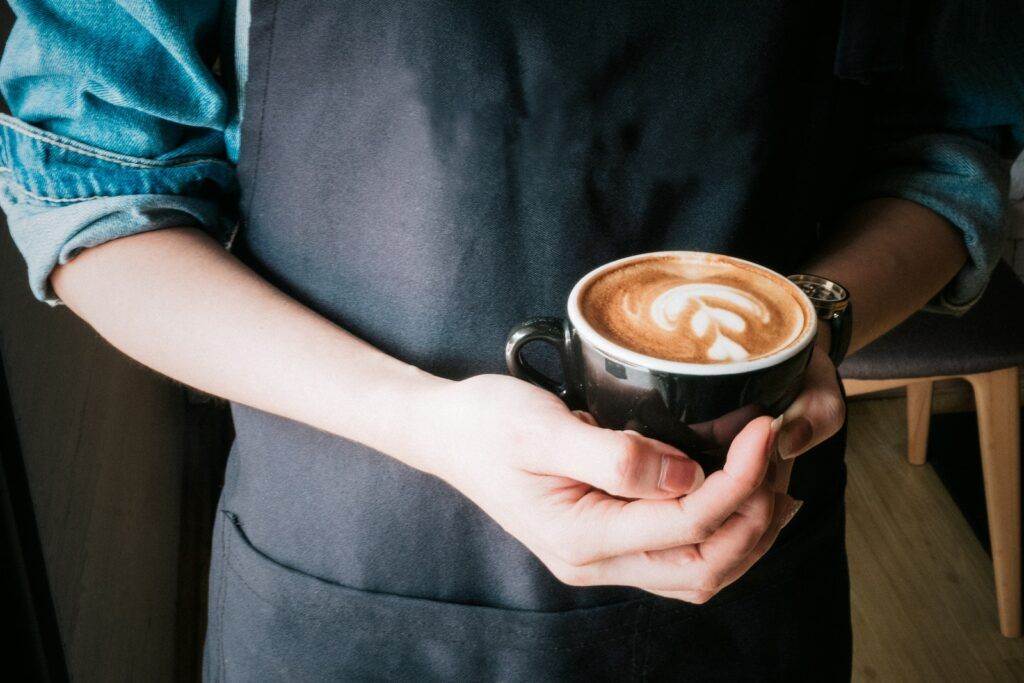 Woman Holding Mug of Cappuccino