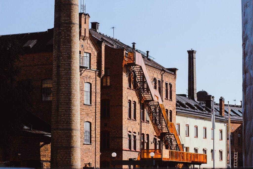 brown heavy equipment with retractable ladder beside building