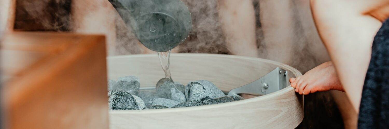 a person pouring water into a glass