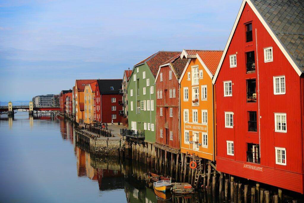 red and brown concrete houses beside river during daytime