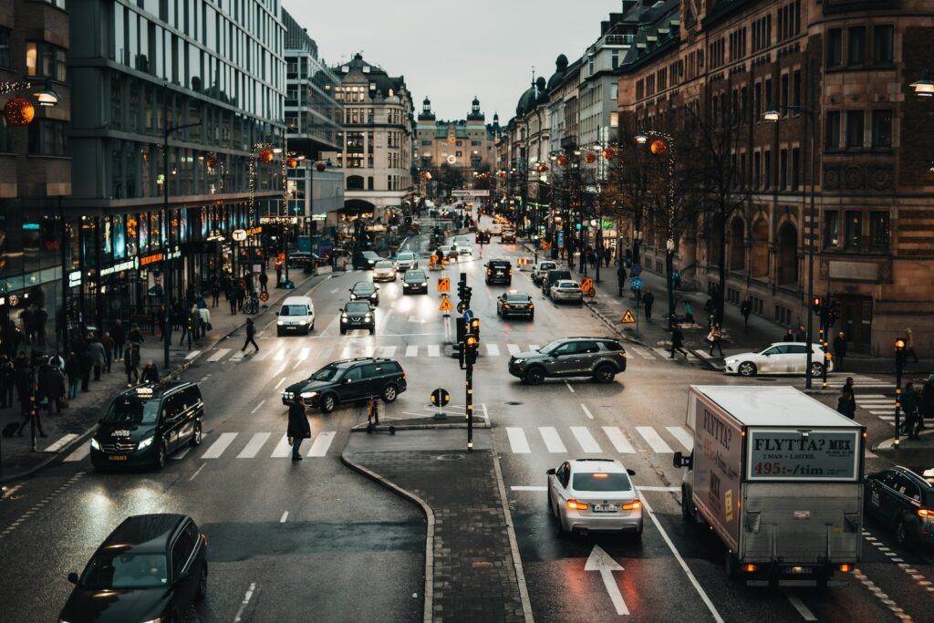 cars on road between buildings during daytime