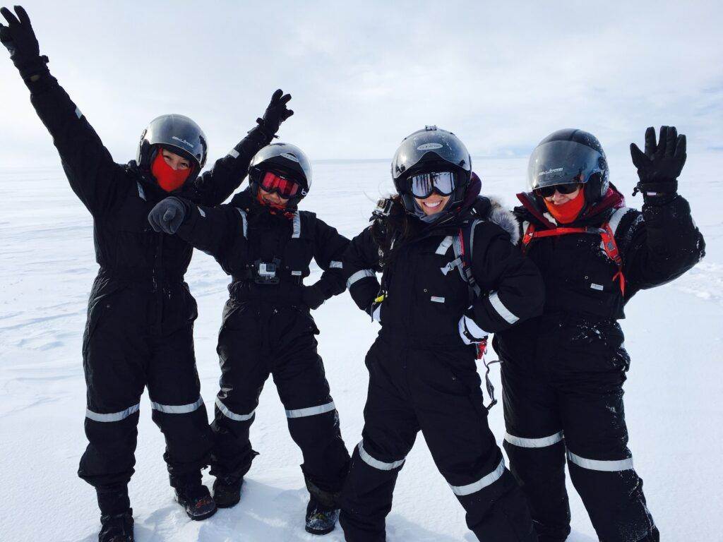 Four Person Wearing Black Snow Suit