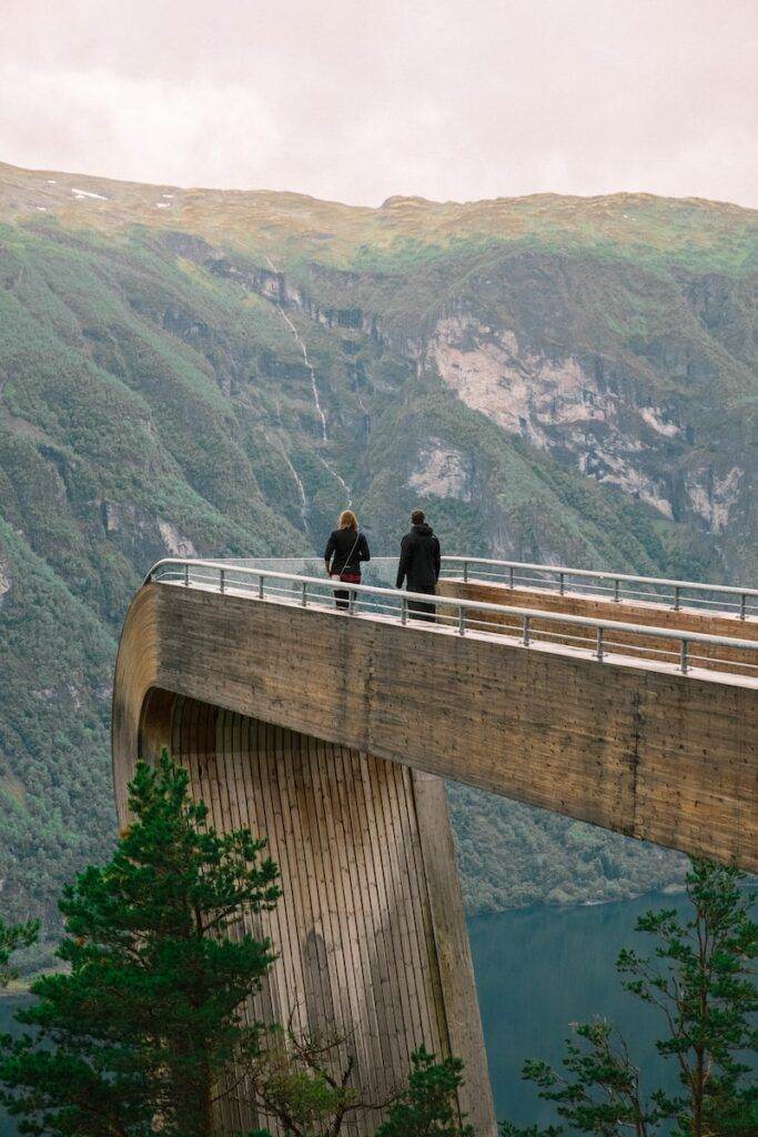 man and woman kissing on bridge during daytime