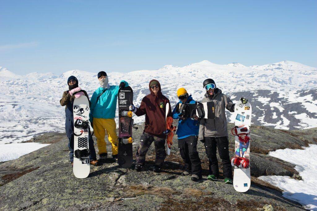 group of people wearing blue and red helmet and blue helmet standing on gray rocky ground