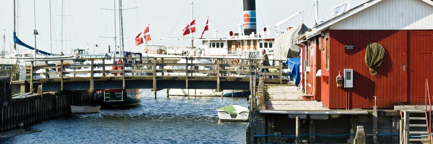 white and red boat on dock during daytime