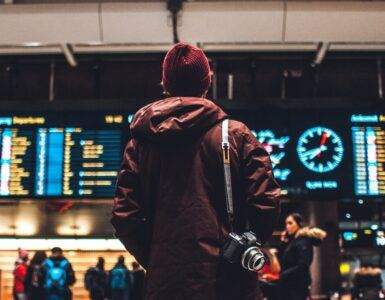 person looking up to the flight schedules