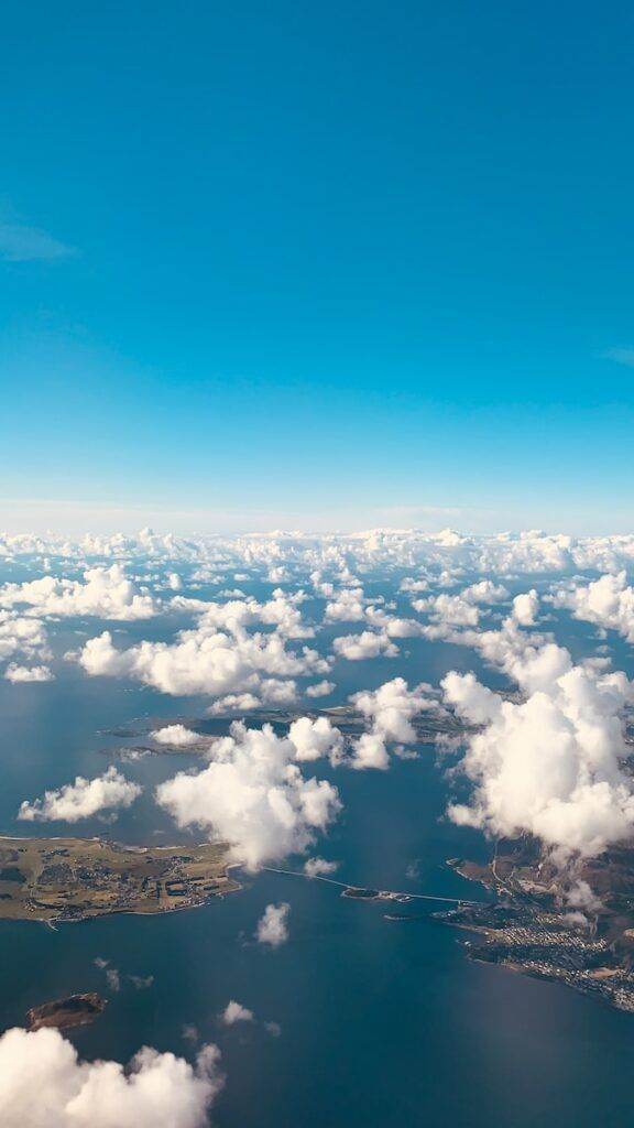 body of water under white clouds