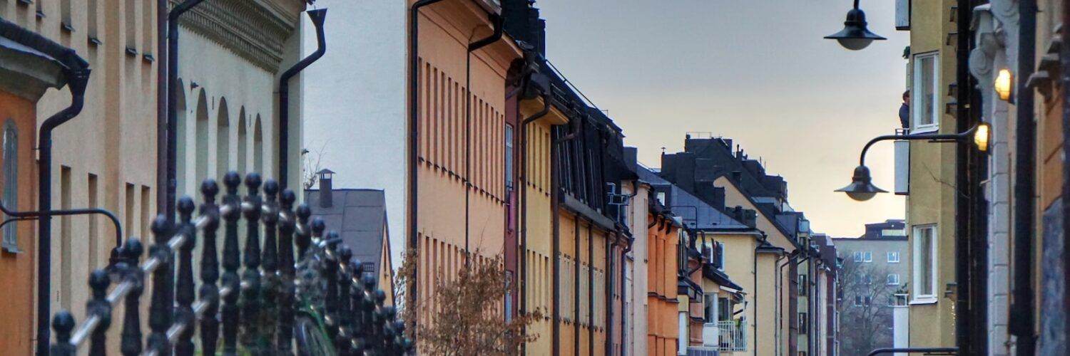 black street light near brown concrete building during daytime