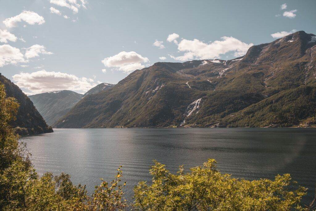 a body of water with a mountain in the background