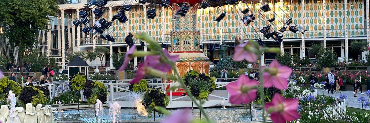 a fountain with a carousel in the background