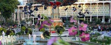 a fountain with a carousel in the background