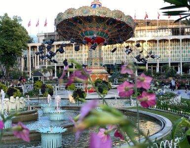 a fountain with a carousel in the background