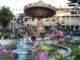 a fountain with a carousel in the background