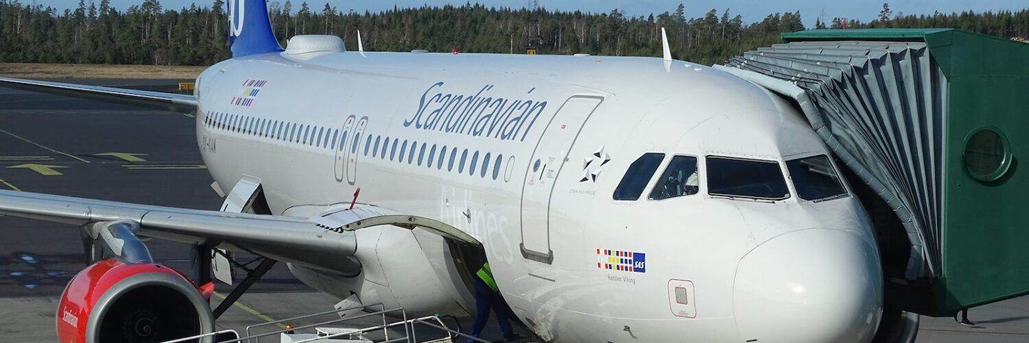 truck parked near commercial airplane on airport