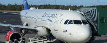 truck parked near commercial airplane on airport