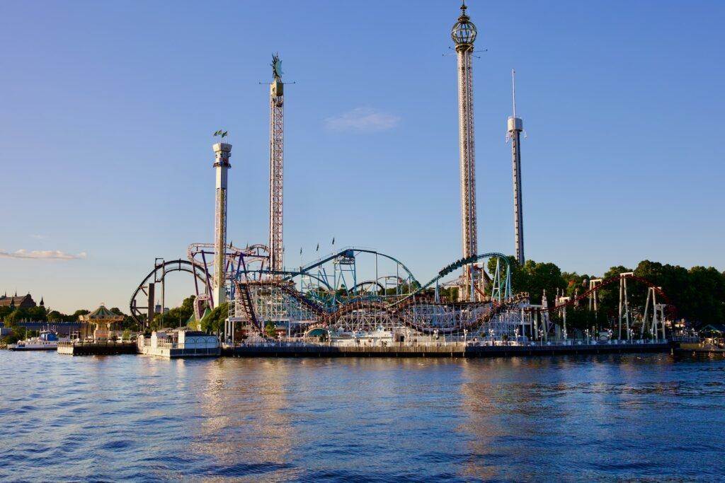 a roller coaster next to a body of water