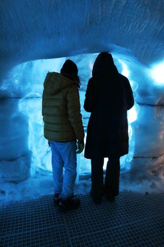 a couple of people that are standing in a tunnel