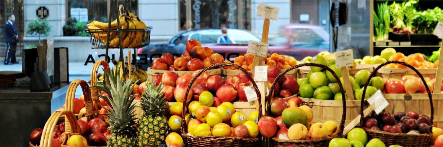 a bunch of baskets filled with different types of fruit