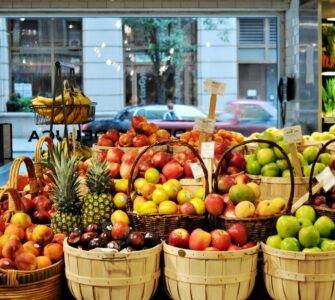 a bunch of baskets filled with different types of fruit