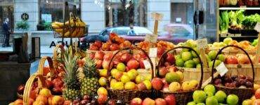 a bunch of baskets filled with different types of fruit