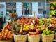 a bunch of baskets filled with different types of fruit