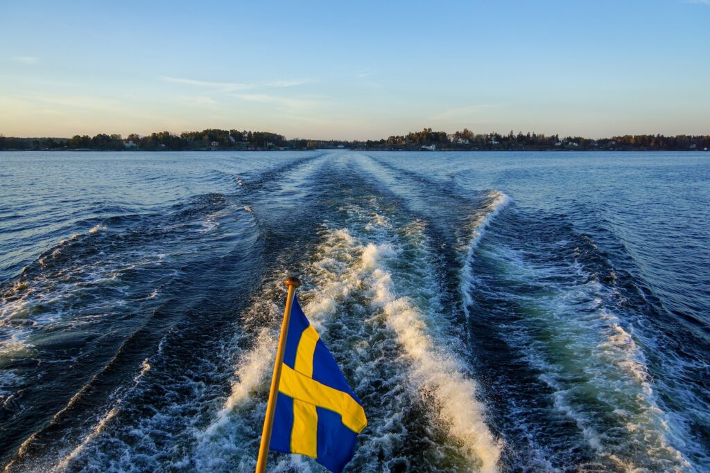 blue and yellow flag on body of water during daytime