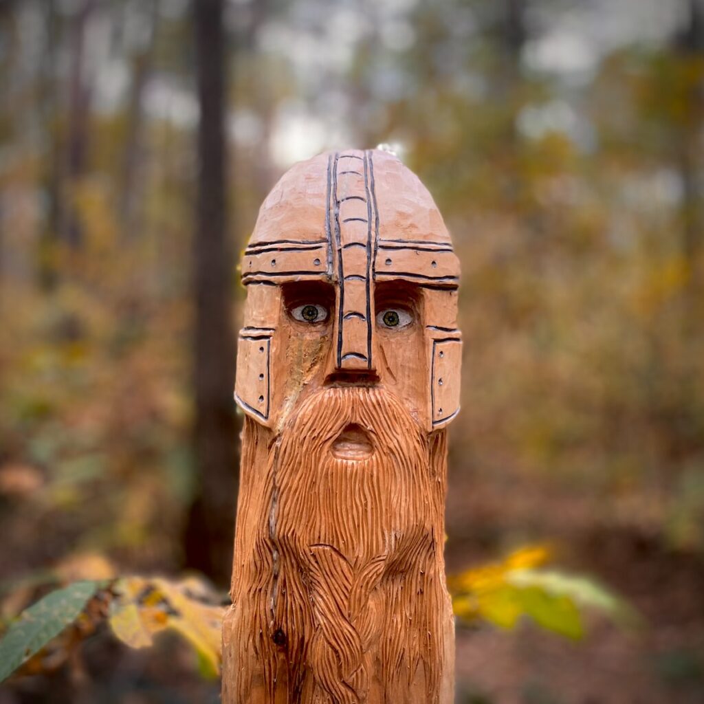 a wooden carving of a man with a beard